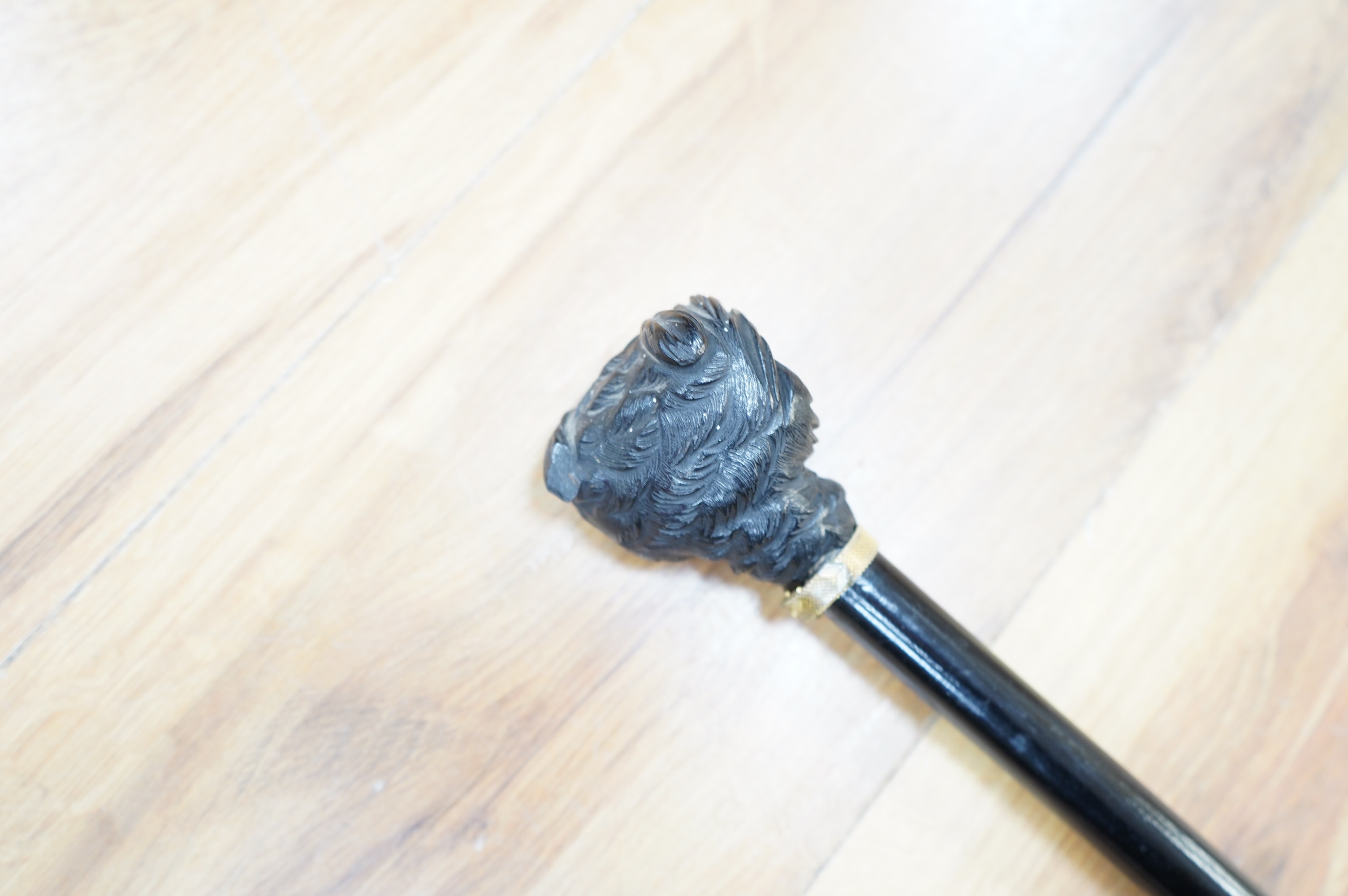 A Victorian ebony 'owl's head' walking stick, 85cm long. Condition - good.